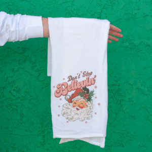 White Cotton Flour Sack Tea Towel | "Don't Stop Believin'" Vintage Santa face for kitchen Christmas and holiday decor and gift.