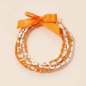 Seed Bead Stretch Bracelet l OSU Orange and White beads with gold accent beads and an orange fabric bowl detail.